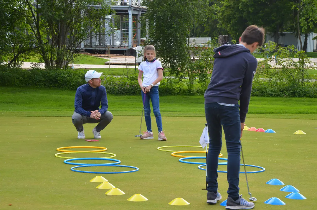 Mini-Golf für den Nachwuchs mit Pro Fabian Michelberger (in der Hocke)